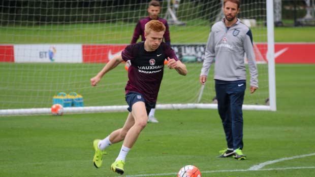 England Under-21s forward Duncan Watmore lines-up a shot in training under the watchful eye of Gareth Southgate.